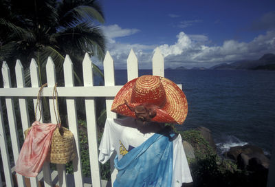 Clothes hanging on fence at seashore