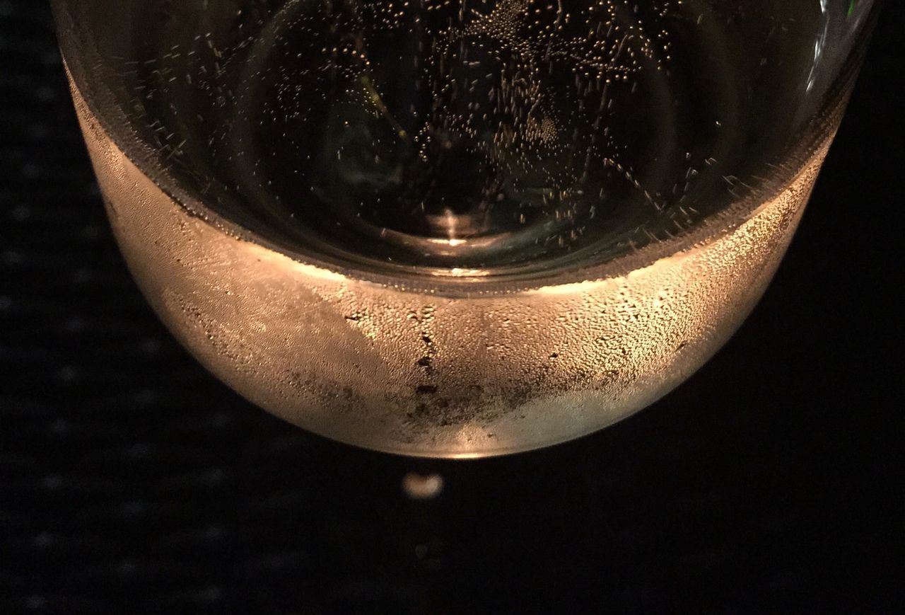 glass - material, drink, indoors, transparent, close-up, refreshment, food and drink, drinking glass, freshness, glass, still life, water, studio shot, table, reflection, black background, bubble, no people, drop, alcohol