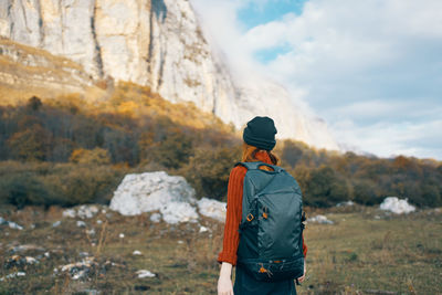 Rear view of man standing on rock