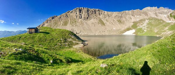 View of calm lake against mountain range
