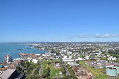 High angle view of townscape by sea against clear sky