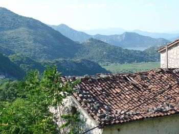 High angle view of townscape by mountains against sky