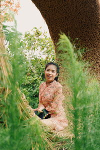 Portrait of smiling young woman on land