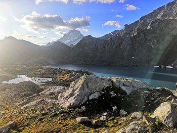 Scenic view of lake by mountains against sky