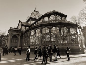 Group of people walking in front of historical building