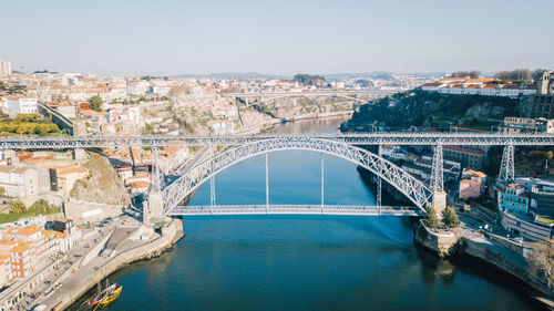 Aerial view of arch bridge over river in city