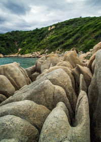 Scenic view of rocks on land against sky