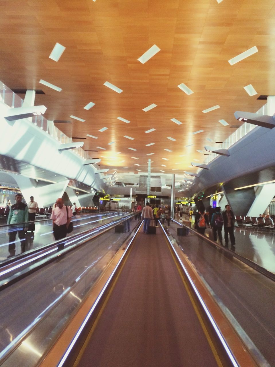 transportation, indoors, illuminated, mode of transport, travel, road marking, airport, the way forward, men, large group of people, ceiling, city life, person, diminishing perspective, lifestyles, public transportation, incidental people, road, journey