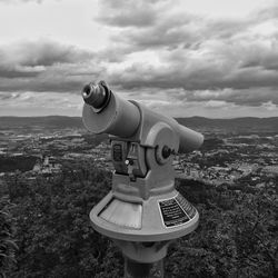 Coin-operated binoculars against sky