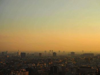 Cityscape against clear sky during sunset