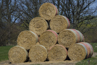 Hay bales on field against sky