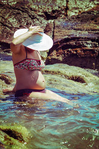 Rear view of woman in swimming pool