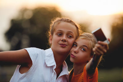Close-up of girls doing selfie outdoors