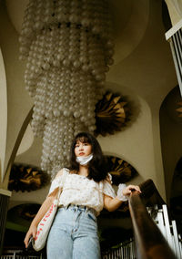 Portrait of smiling young woman standing at home