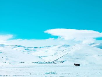 Scenic view of snowcapped mountain against cloudy sky