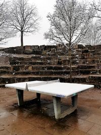 Empty bench in park during winter