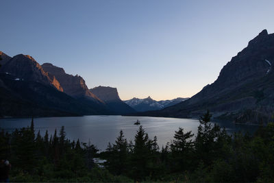 Scenic view of lake and mountains against clear sky