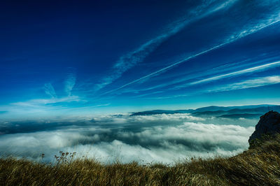 Scenic view of landscape against cloudy sky