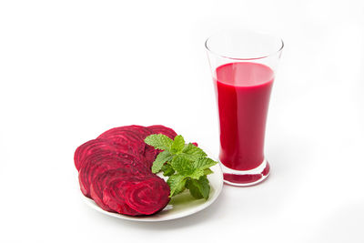 Close-up of red drink against white background