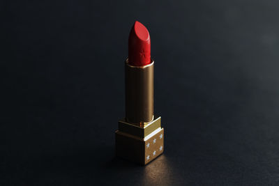 Close-up of red lipstick on black background
