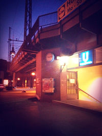 Illuminated underground walkway at night