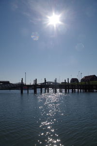 Scenic view of river by buildings against sky