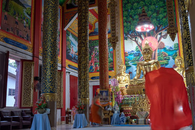 Low angle view of statue against illuminated building