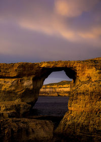 Arch bridge against sky during sunset