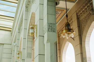 Low angle view of illuminated lanterns hanging outside building