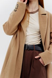 Midsection of woman standing against white background