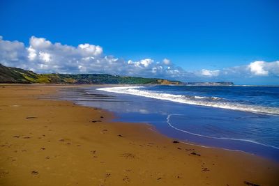 View of beach against cloudy sky