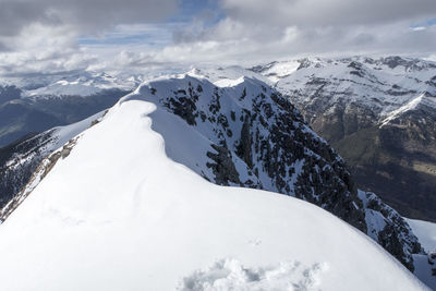 Scenic view of snow covered mountains against sky