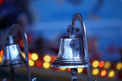 Close-up of silver colored bells at night