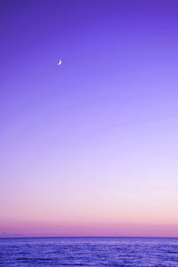 Scenic view of sea against clear sky at sunset