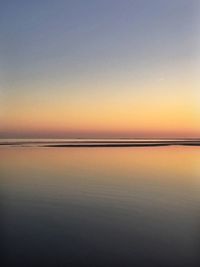 Scenic view of sea against clear sky during sunset