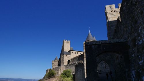 Low angle view of historical building against blue sky