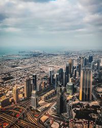 High angle view of cityscape against cloudy sky