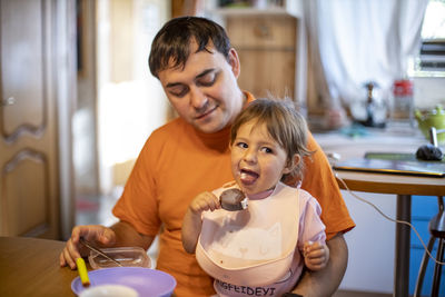 Portrait of smiling boy and woman at home