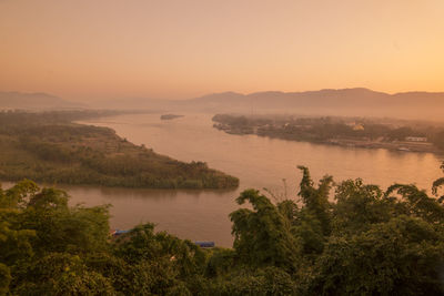 Scenic view of lake against clear sky during sunset