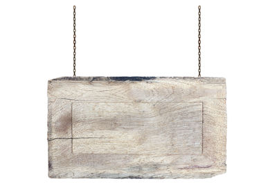 Close-up of clothes hanging on wood against white background