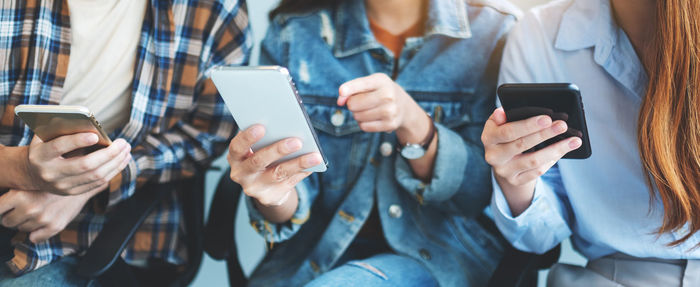 Midsection of woman using mobile phone