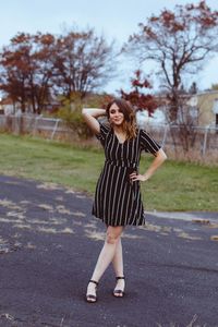 Full length of young woman standing outdoors