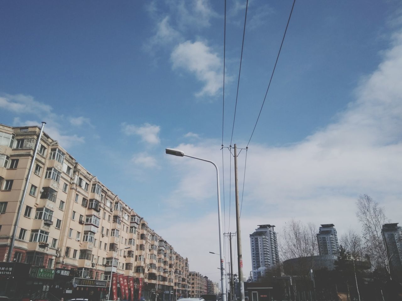 LOW ANGLE VIEW OF BUILDINGS AGAINST SKY