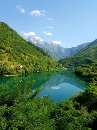 Scenic view of lake and mountains against sky