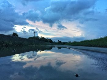 Scenic view of lake against cloudy sky