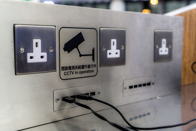 Close-up of information sign on wall