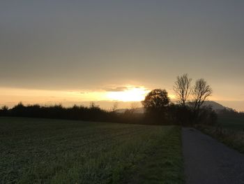 Scenic view of field against sky during sunset