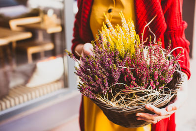 Close-up of woman holding flower bouquet