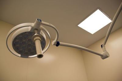 Low angle view of electric lamp hanging on ceiling