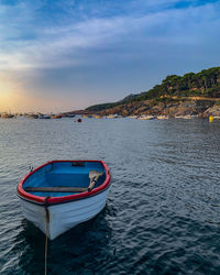 Boat moored on sea against sky